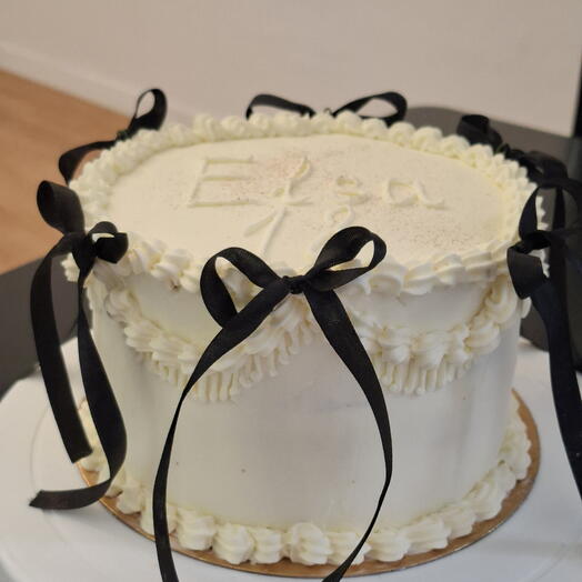 Tarta blanca de Lambeth con lazos negros para el cumpleanos de una adolescente