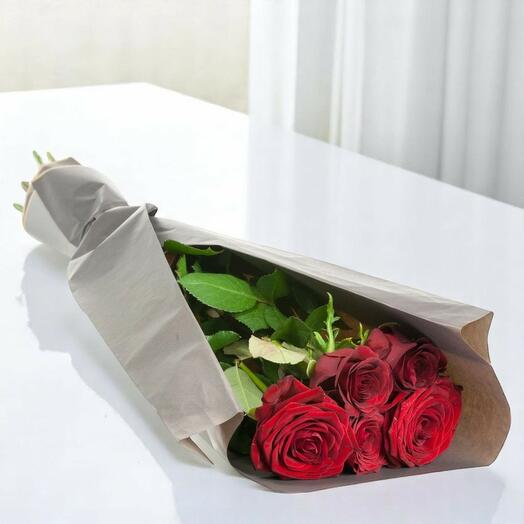 5 red roses wrapped in paper