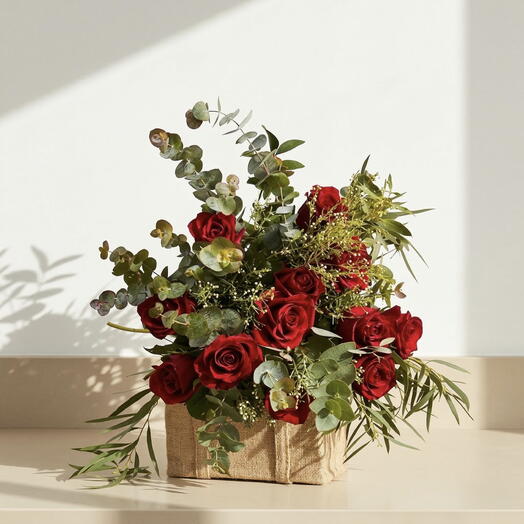 Winter Elegance – Arrangement of red roses with natural greenery