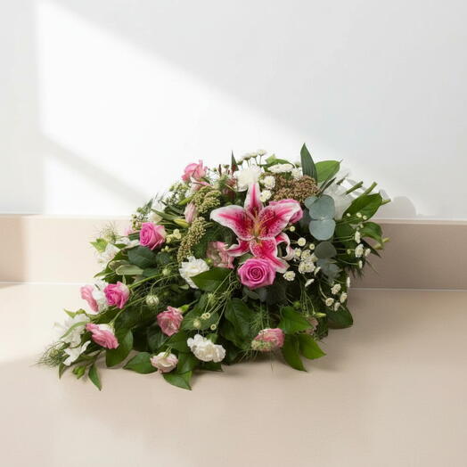 Funeral cushion with lilies, roses and wildflowers in pink tones