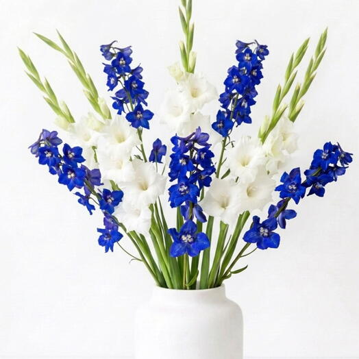 Bouquet of white gladioli and blue delphiniums.