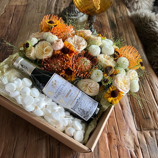 Caja brillante con flores y vino