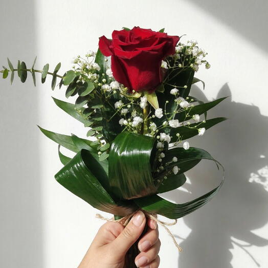 Rose detail– Single red rose with baby's breath and natural greenery