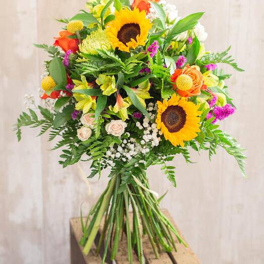 Statice, alstroemerias, sunflowers, orange roses
